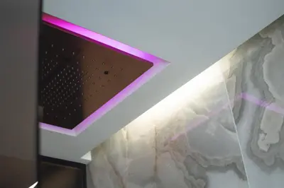 a room with a ceiling with a pink light at Tritone Luxury Suites Fontana di Trevi in Rome
