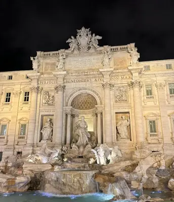 a building with a fountain in front of it at Tritone Luxury Suites Fontana di Trevi in Rome