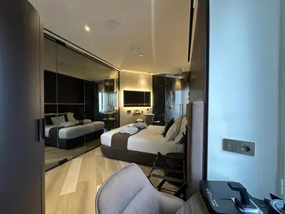 a hotel room with two beds and a desk at Tritone Luxury Suites Fontana di Trevi in Rome