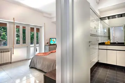 a bedroom with a bed and a sink in a room at Appartamento Romantico a Trastevere in Rome