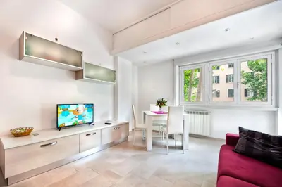 a living room with a red couch and a tv at Appartamento Romantico a Trastevere in Rome