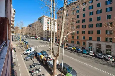 a city street with cars parked in a parking lot at Appartamento Romantico a Trastevere in Rome