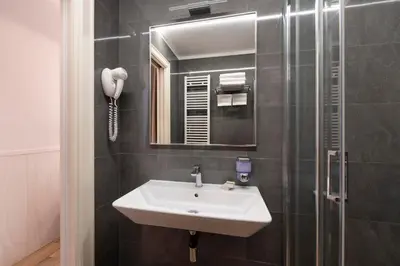 a bathroom with a sink and a mirror at Hotel de' Clementi in Rome