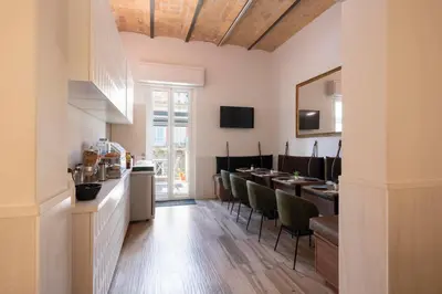 a kitchen and dining room with a table and chairs at Hotel de' Clementi in Rome