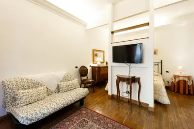 a living room with a couch and a flat screen tv at Altobelli Apartment in Rome