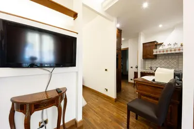 a living room with a large flat screen tv on a wall at Altobelli Apartment in Rome