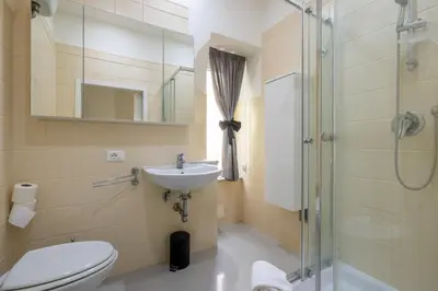 a bathroom with a toilet and a sink and a shower at Vatican Apartment near Metro Ottaviano in Rome