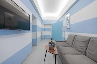 a living room with a couch and a tv at Vatican Apartment near Metro Ottaviano in Rome
