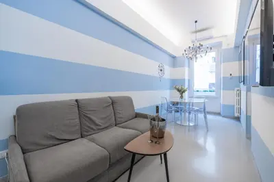 a living room with a couch and a table at Vatican Apartment near Metro Ottaviano in Rome