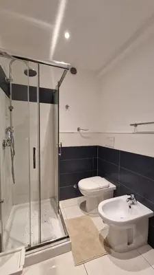 a bathroom with a shower and a toilet and a sink at LG colosseum Rome apartment in Rome