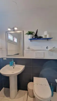 a bathroom with a sink and a toilet and a mirror at LG colosseum Rome apartment in Rome