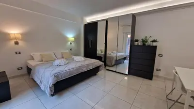 a bedroom with a bed and a large mirror at LG colosseum Rome apartment in Rome