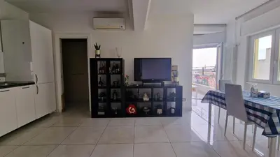 a living room with a television and a table with chairs at LG colosseum Rome apartment in Rome