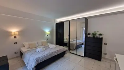 a bedroom with a large bed and a mirror at LG colosseum Rome apartment in Rome