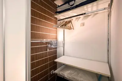 a small refrigerator in a room with brown tiles at Minerva Apartment in Rome