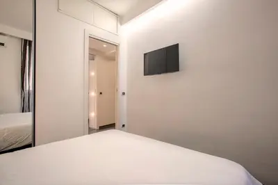 a bedroom with a bed and a television on a wall at Minerva Apartment in Rome