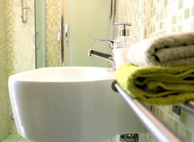 a bathroom with a sink and towels on a counter at Rome Sleep Home Bed & Breakfast in Rome