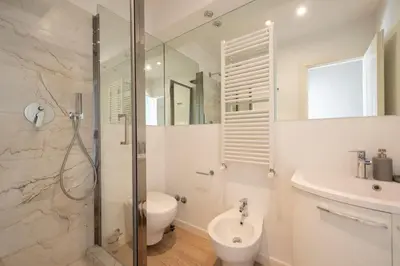 a bathroom with a shower and a toilet and a sink at Lucrezio Caro Luxury Apartment in Rome