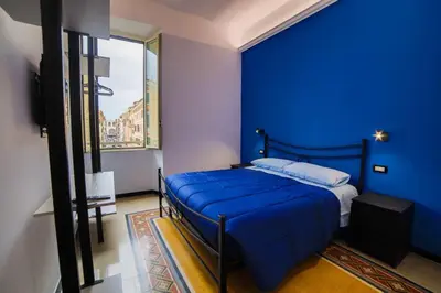 a blue bedroom with a bed with a blue wall at P88 guesthouse in Rome
