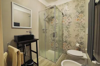 a bathroom with a shower with a toilet and a sink at P88 guesthouse in Rome