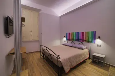 a bedroom with a bed with a rainbow canopy at P88 guesthouse in Rome
