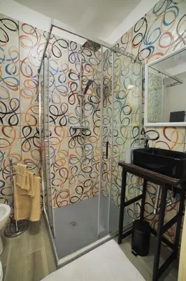 a bathroom with a shower with a sink and a mirror at P88 guesthouse in Rome