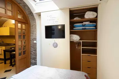 a bedroom with a bed and a tv in a room at Le Petit Prince in Rome