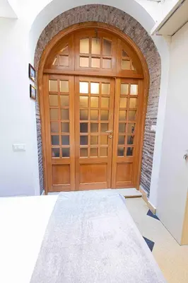 a wooden door in a room with a brick wall at Le Petit Prince in Rome