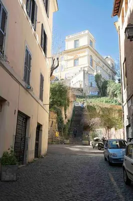 an alley with buildings and cars parked on a street at Le Petit Prince in Rome