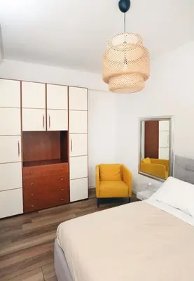 a bedroom with a bed and a chair and a mirror at Bibi’s house Vaticano in Rome