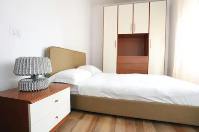 a bedroom with a bed and a dresser with a lamp at Bibi’s house Vaticano in Rome