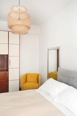 a bedroom with a bed and a yellow chair at Bibi’s house Vaticano in Rome
