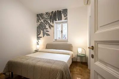 a small bedroom with a bed and a window at Eri's Apartment in Rome
