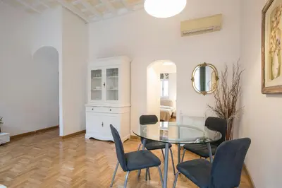 a dining room with a glass table and chairs at Eri's Apartment in Rome