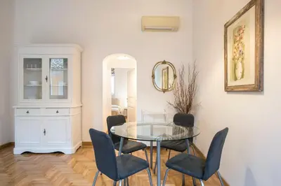 a dining room with a glass table and chairs at Eri's Apartment in Rome