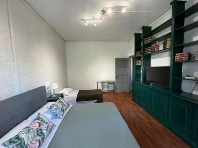a room with a bed and a television in it at Room Sapienza in Rome