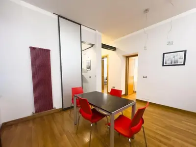 a dining room with red chairs and a table at Maison Vittorio Borgo Pio in Rome