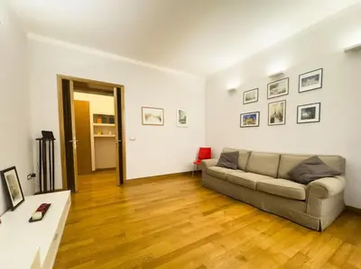 a kitchen with a table and red chairs in a room at Maison Vittorio Borgo Pio in Rome
