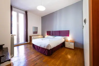 a bedroom with a bed and a large window at Casa Nica in Rome