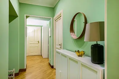 a hallway with green walls and a mirror at Lion Aparts Rome in Rome