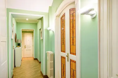 a hallway with green walls and stained glass doors at Lion Aparts Rome in Rome