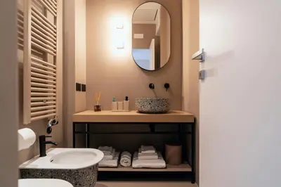 a bathroom with a sink and a mirror at The Flow - Via Del Corso in Rome