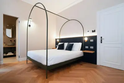 a bedroom with a bed with a metal canopy at The Flow - Via Del Corso in Rome