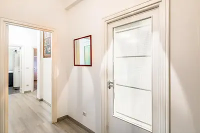 a hallway with a door with a window at Lion Aparts Rome - Vatican City in Rome