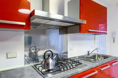 a kitchen with two tea pots on a stove at Lion Aparts Rome - Vatican City in Rome