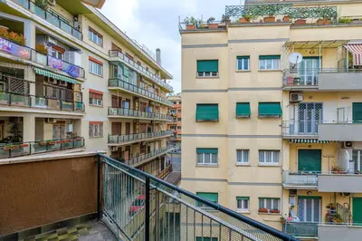 an apartment building with balconies and a staircase in front at Lion Aparts Rome - Vatican City in Rome