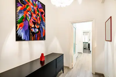 a living room with a painting of a lion at Lion Aparts Rome - Vatican City in Rome