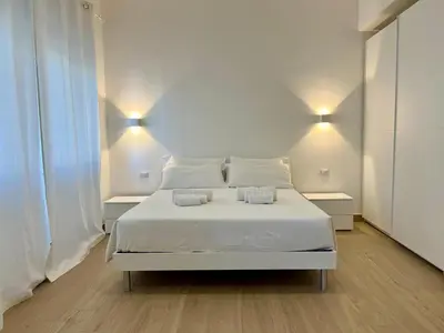 a living room with two chairs and a desk in it at Trastevere Tre Porte Apartments in Rome