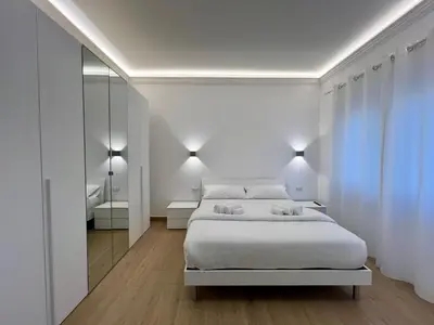 a bedroom with two chairs and a bed and a desk at Trastevere Tre Porte Apartments in Rome