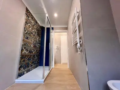 a living room with a glass table and a couch at Trastevere Tre Porte Apartments in Rome